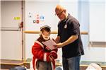 Boy dressed as Santa with drama teacher