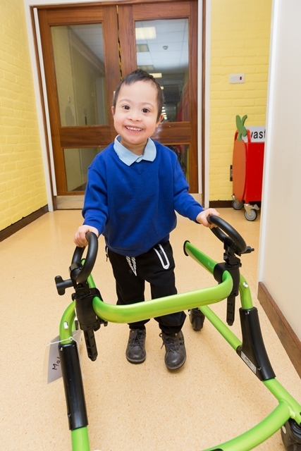 happy young boy with a walking frame
