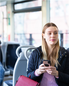 girl on bus with phone