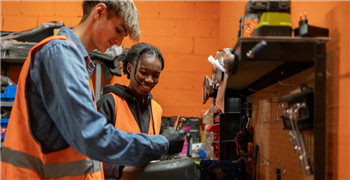 Young people working on an electric motorbike